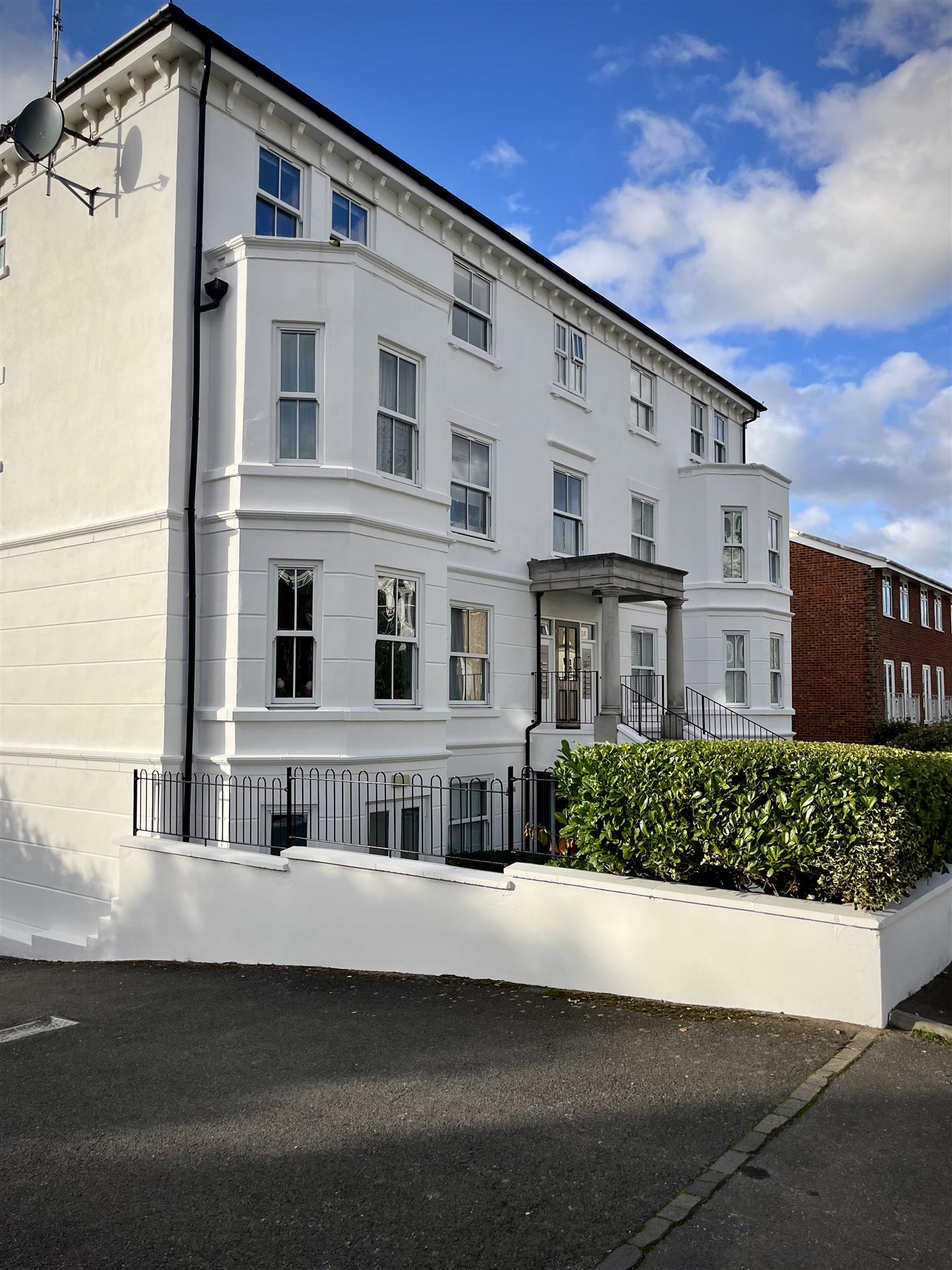 Grand white Victorian apartments street corner view, Essex